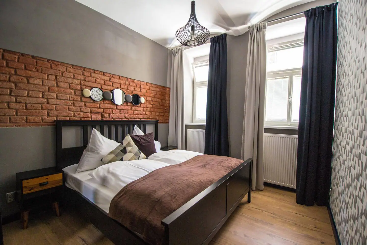 Moderně zařízený byt na Žižkově – ložnice s designovým osvětlením připravená pro hosty